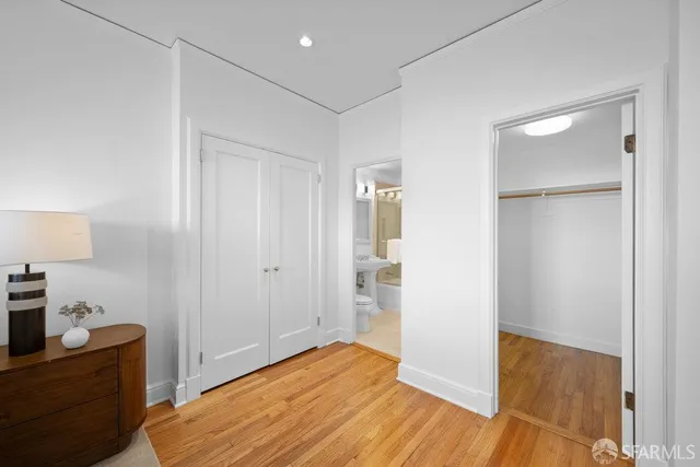 a view of a room with wooden floor and white walls