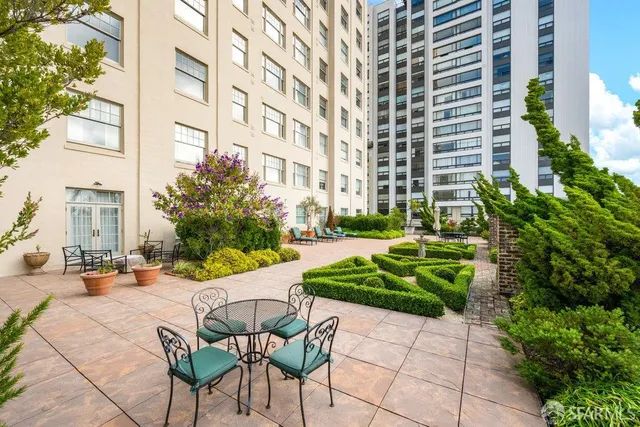 a view of a chair and table in the front with a building