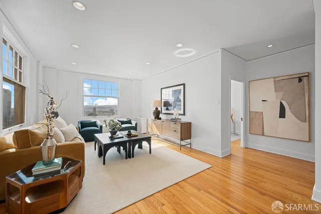 a living room with furniture a table and a large window