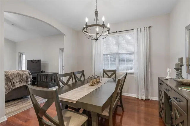 a view of a dining room with furniture and chandelier
