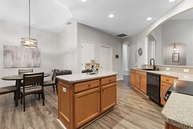 a kitchen with granite countertop a sink and a stove