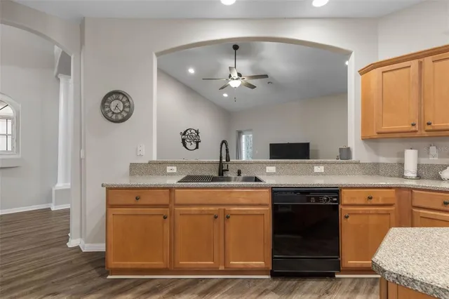 a bedroom with a bed and a flat tv screen on dresser
