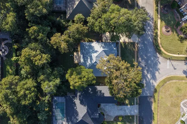an aerial view of a house with a yard and garden