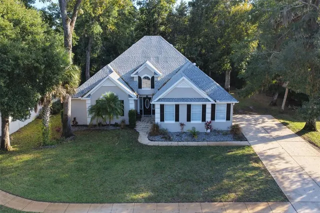 an aerial view of residential houses with outdoor space and trees