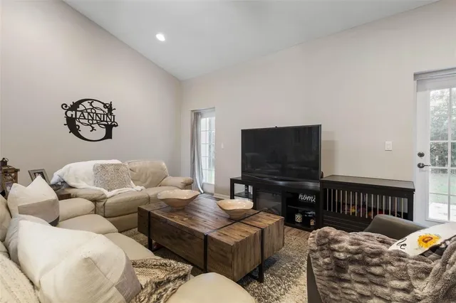 a view of a dining room with furniture a chandelier and wooden floor