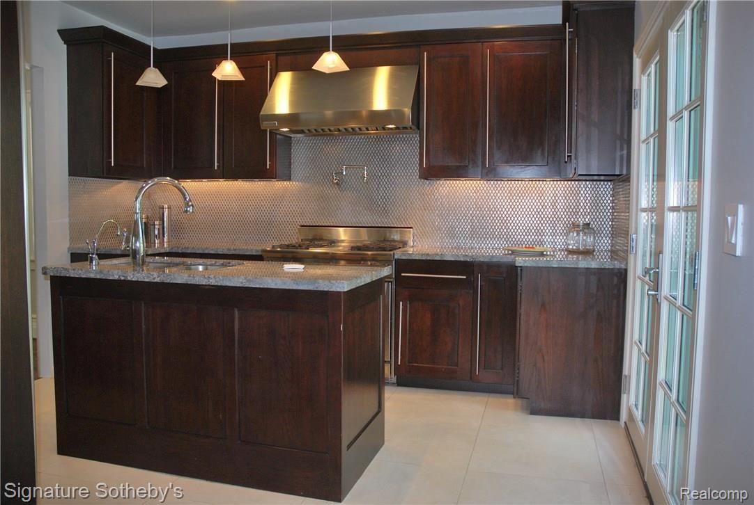 83 Amherst Road Pleasant Ridge, MI 48069 - Photo 7 of 15 Island with Stainless Steel Sink, Separate Instant Hot and Cold Water Faucet, Meile Dishwasher. Plus You have French Doors Opening to Patio.