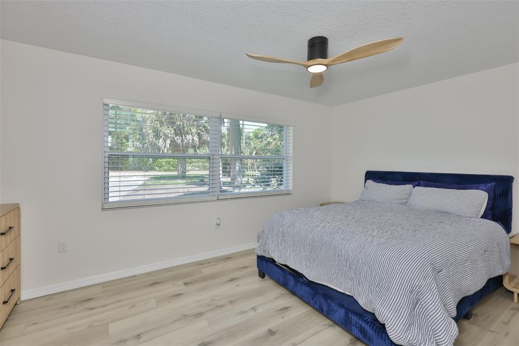 1578 Indian Bay Road Spring Hill, FL 34607 - Photo 29 of 51 a bedroom with a large bed and a large window
