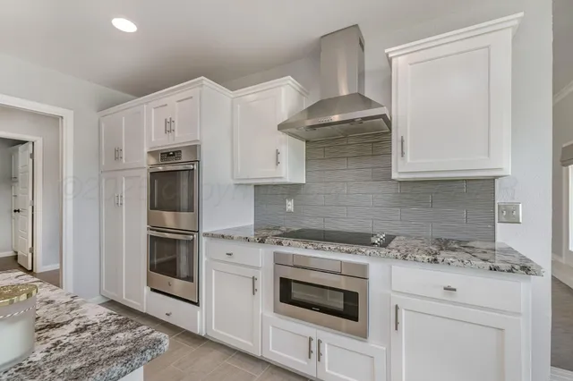 a kitchen with cabinets appliances and a counter space