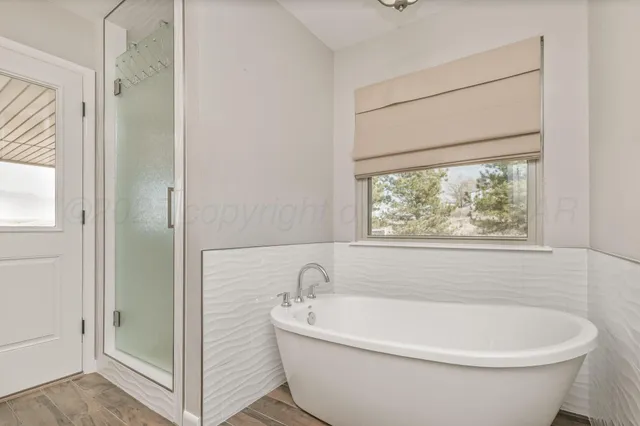 a white bath tub sitting next to a window