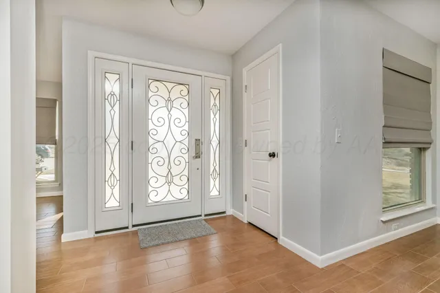 a view of an entryway with wooden floor