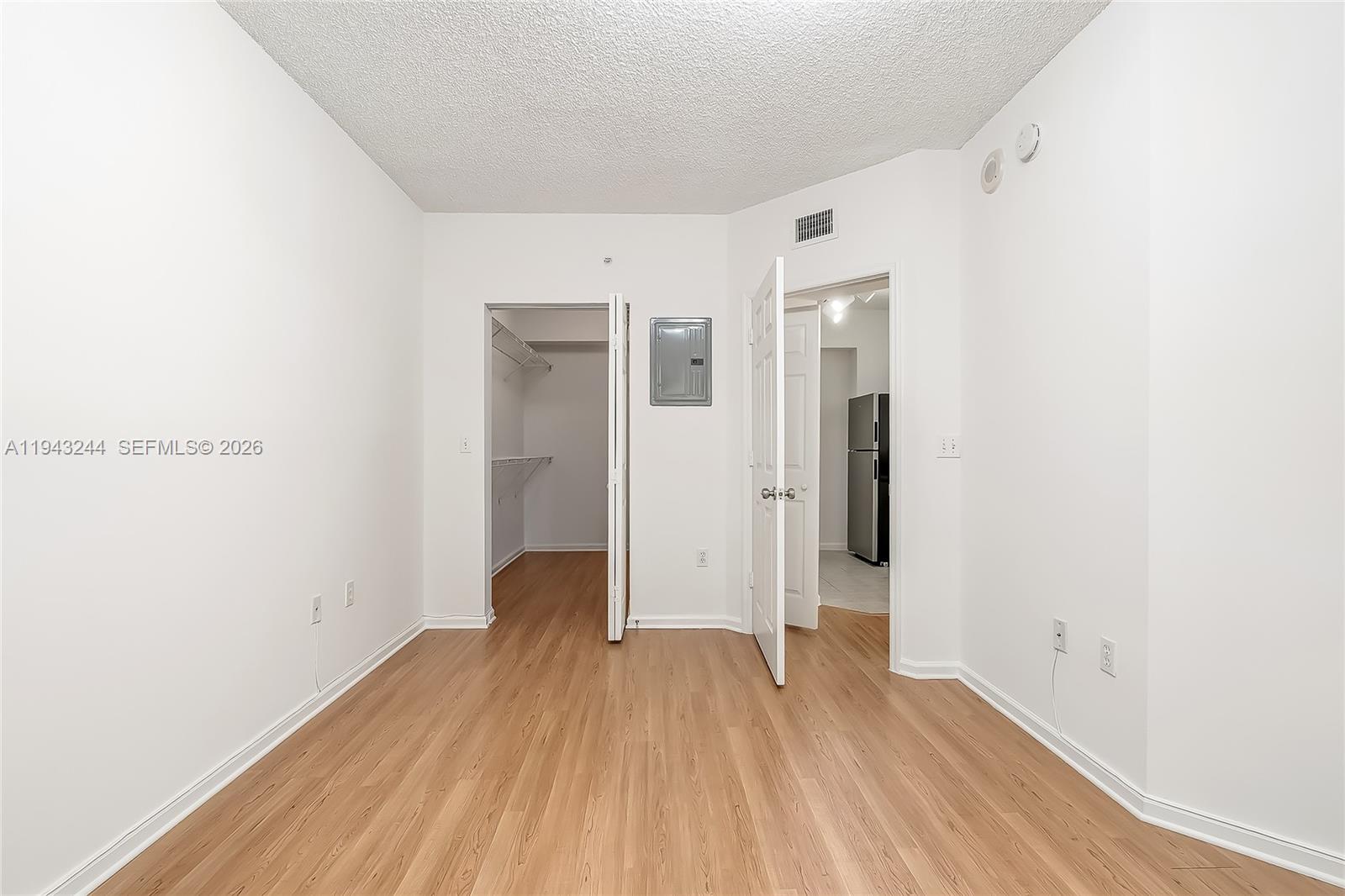 17150 North Bay Road, Unit 2301 Sunny Isles Beach, FL 33160 - Photo 13 of 44 a view of a room with wooden floor and a hallway
