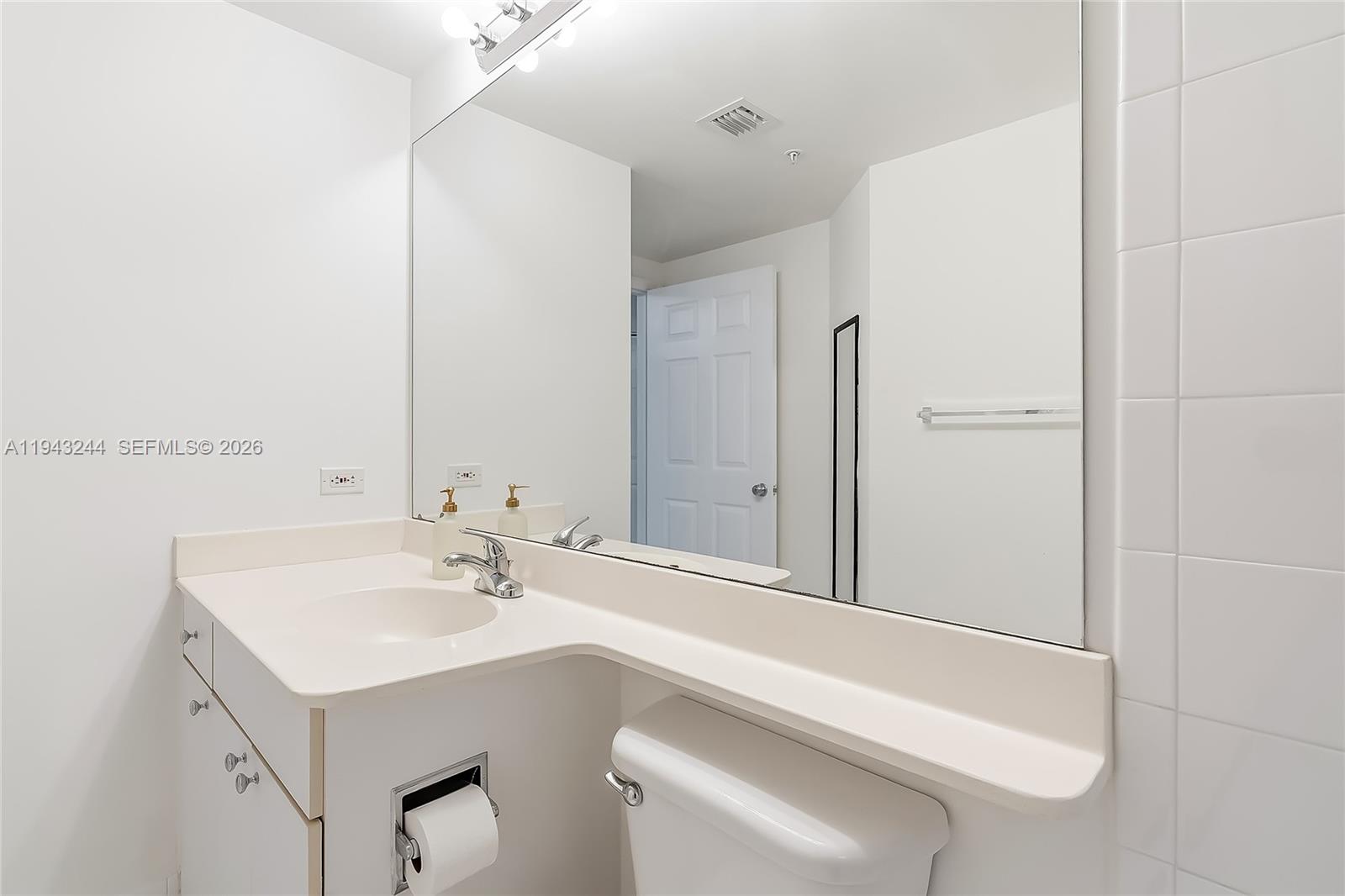 17150 North Bay Road, Unit 2301 Sunny Isles Beach, FL 33160 - Photo 17 of 44 a bathroom with a sink and a mirror