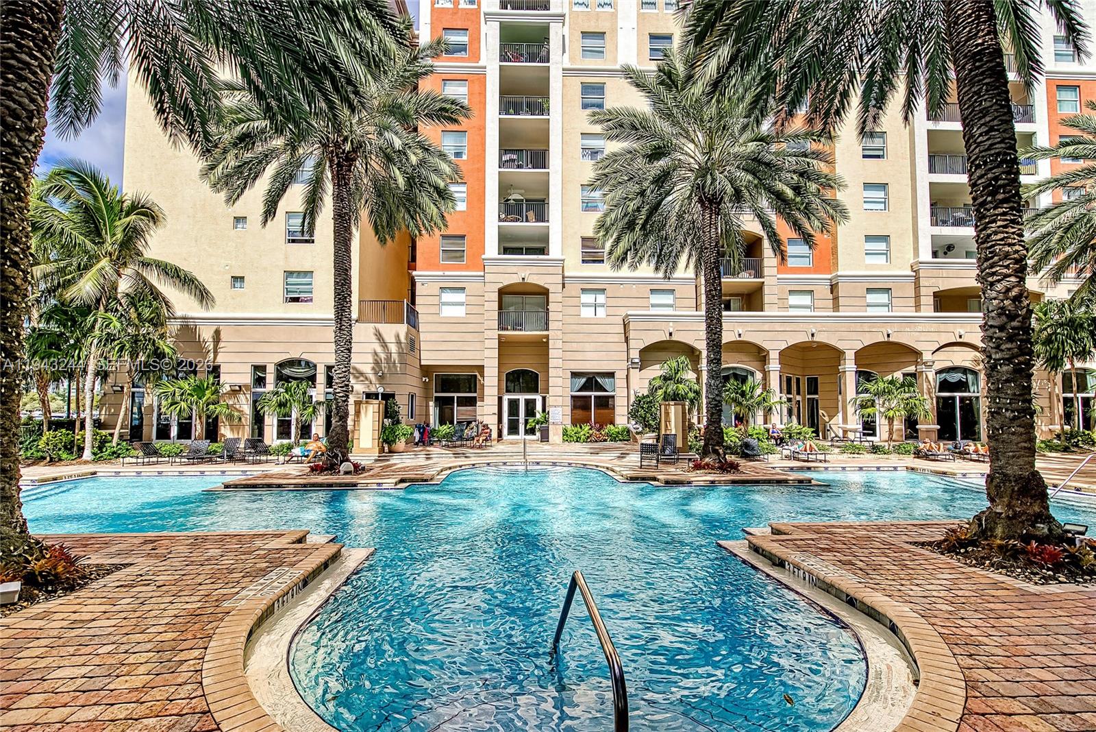 17150 North Bay Road, Unit 2301 Sunny Isles Beach, FL 33160 - Photo 23 of 44 front view of house with a yard and palm trees