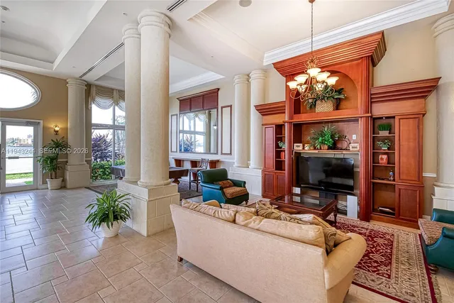 a living room with furniture a window and a flat screen tv