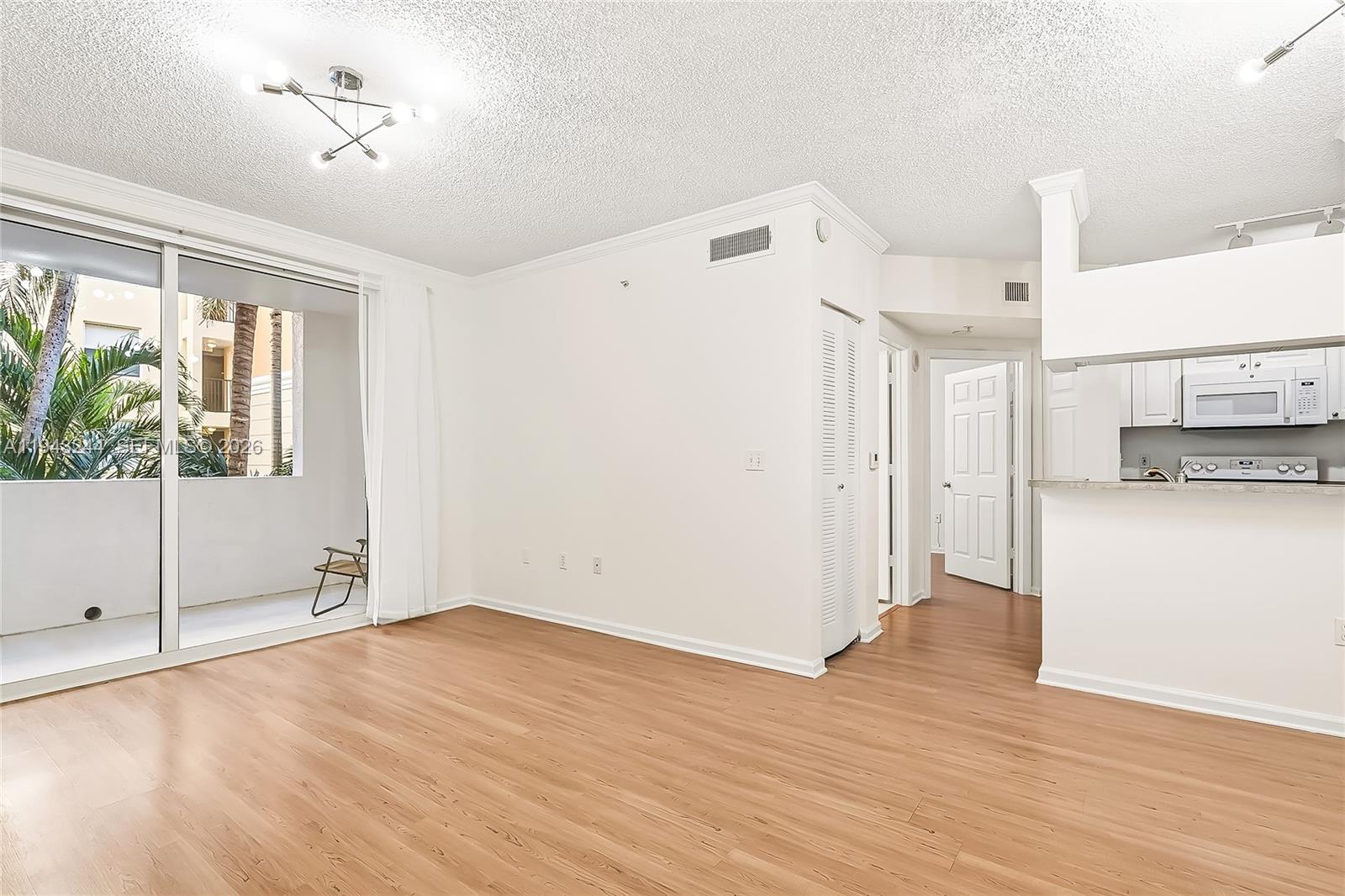 17150 North Bay Road, Unit 2301 Sunny Isles Beach, FL 33160 - Photo 8 of 44 a view of empty room with wooden floor and fan