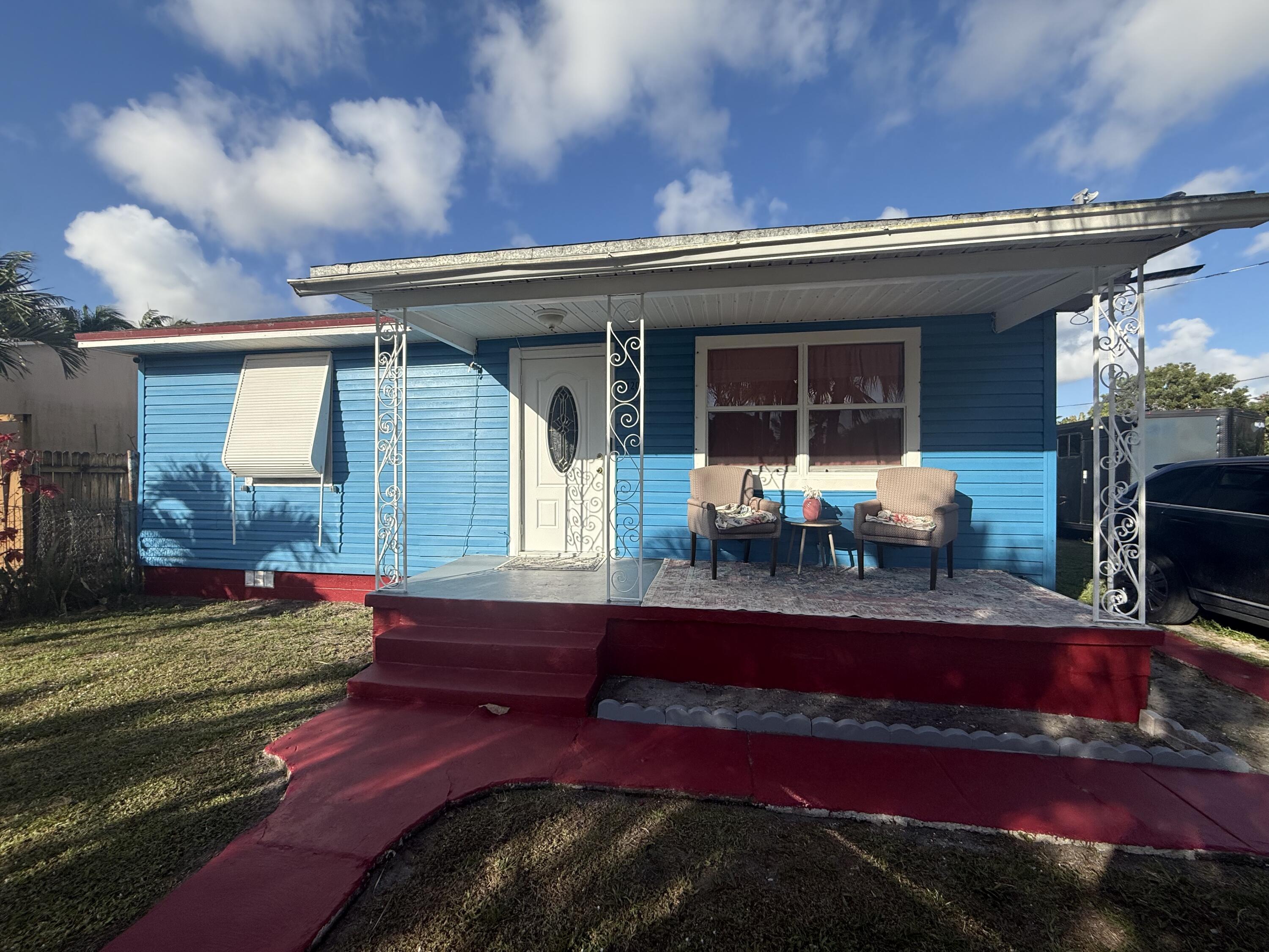 1203 Mathis Street Lake Worth, FL 33461 - Photo 2 of 19 a view of a house with patio