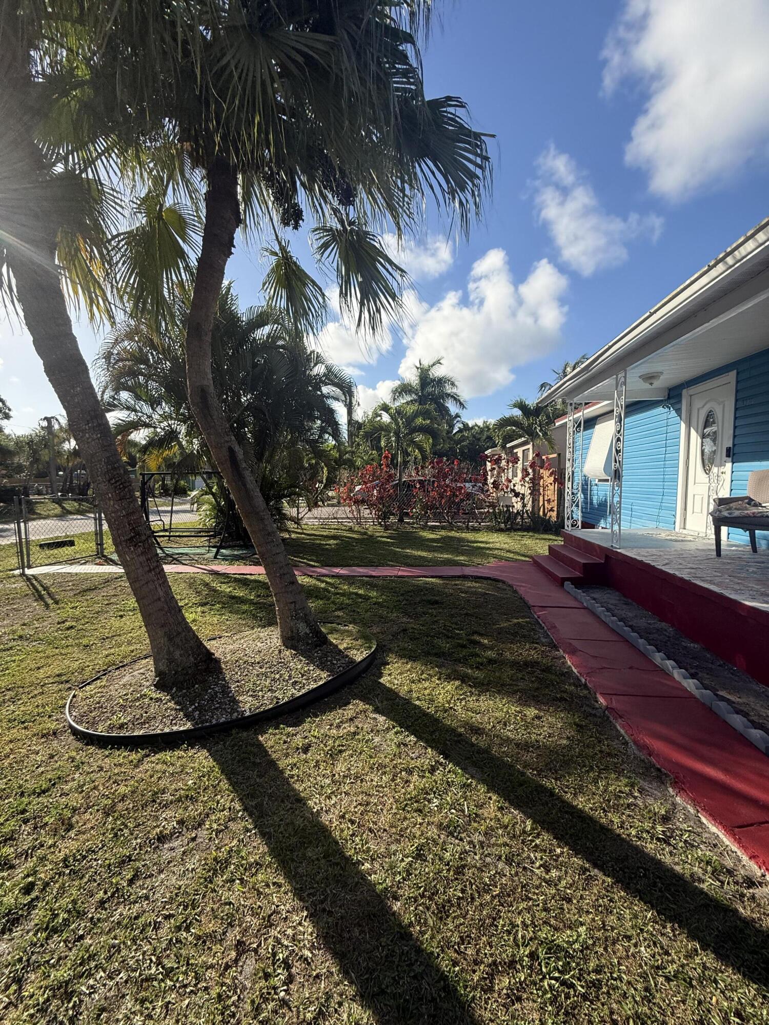 1203 Mathis Street Lake Worth, FL 33461 - Photo 3 of 19 a view of a yard with large trees