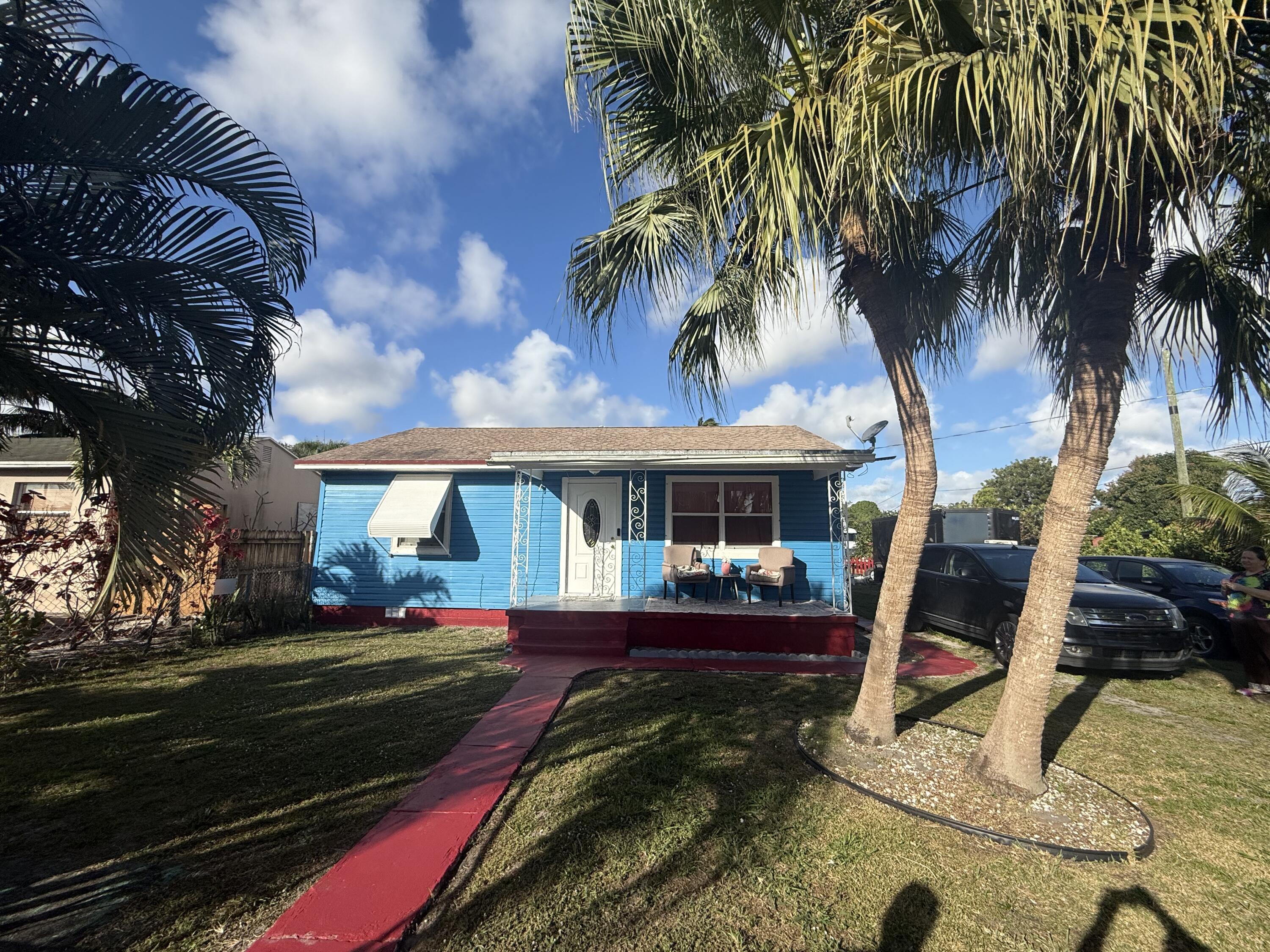 1203 Mathis Street Lake Worth, FL 33461 - Photo 5 of 19 a front view of a house with a yard