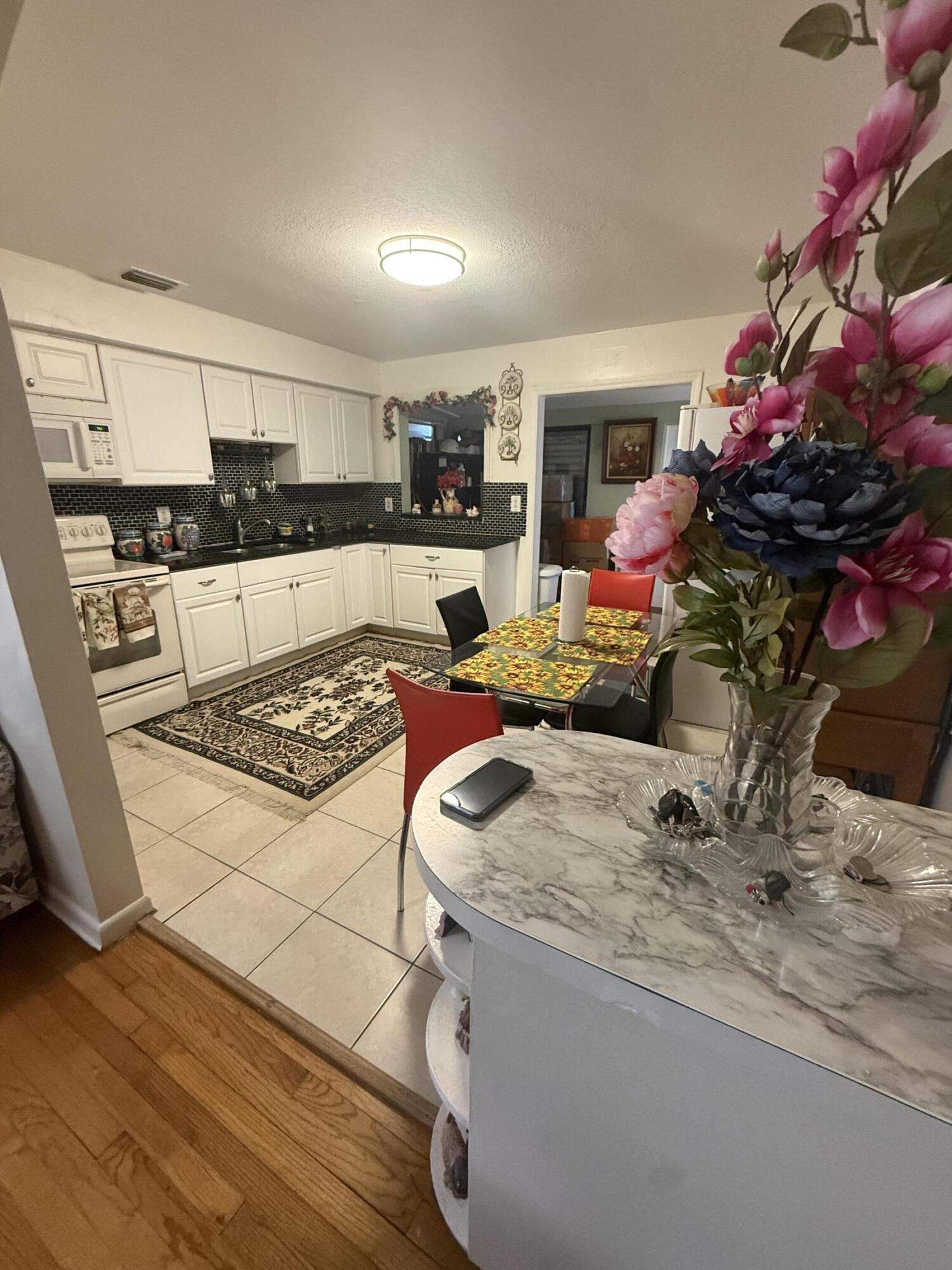1203 Mathis Street Lake Worth, FL 33461 - Photo 7 of 19 a living room with kitchen countertops and a potted plant