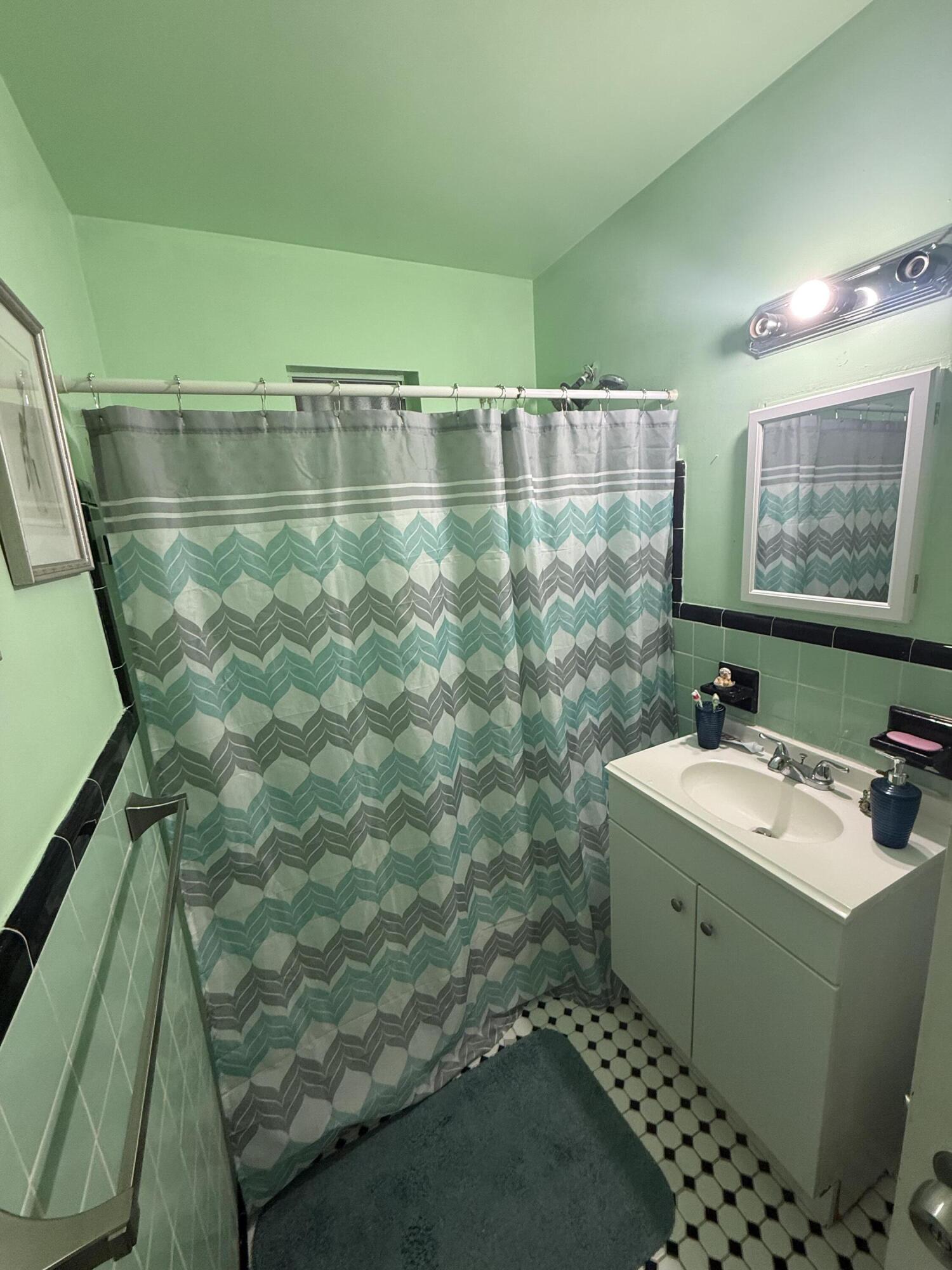 1203 Mathis Street Lake Worth, FL 33461 - Photo 10 of 19 a bathroom with a sink a toilet and shower