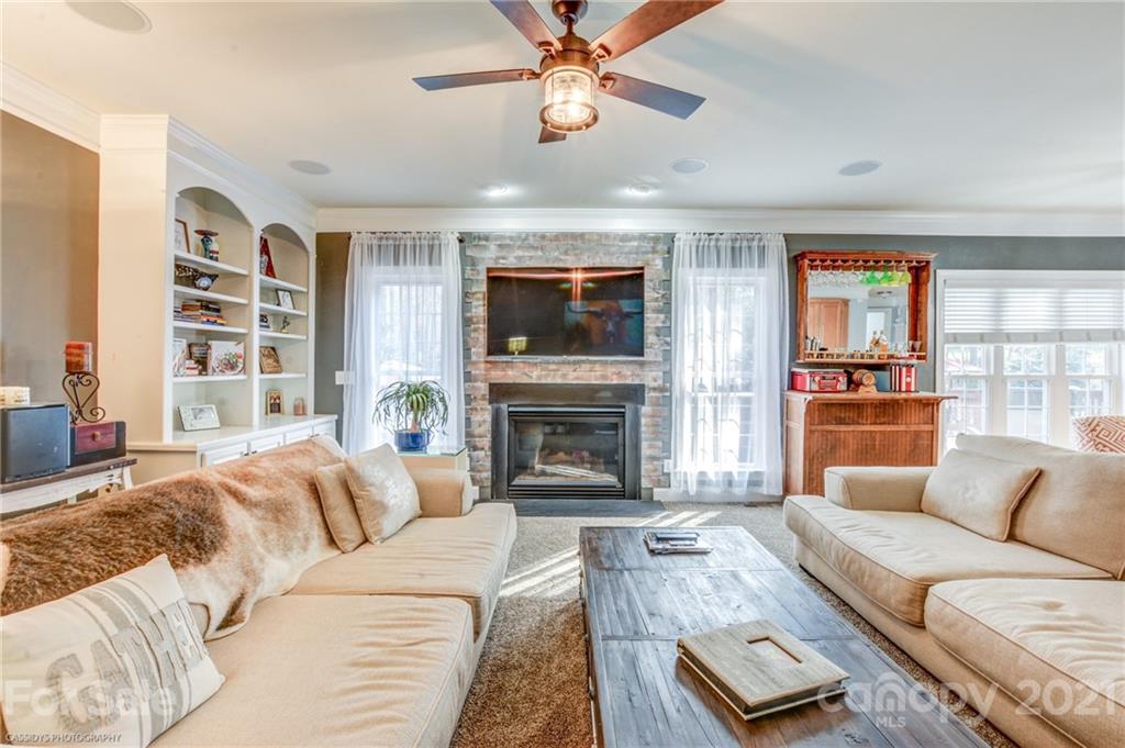 2678 Landing Pointe Drive Clover, SC 29710 - Photo 12 of 48 a living room with furniture a fireplace and a flat screen tv