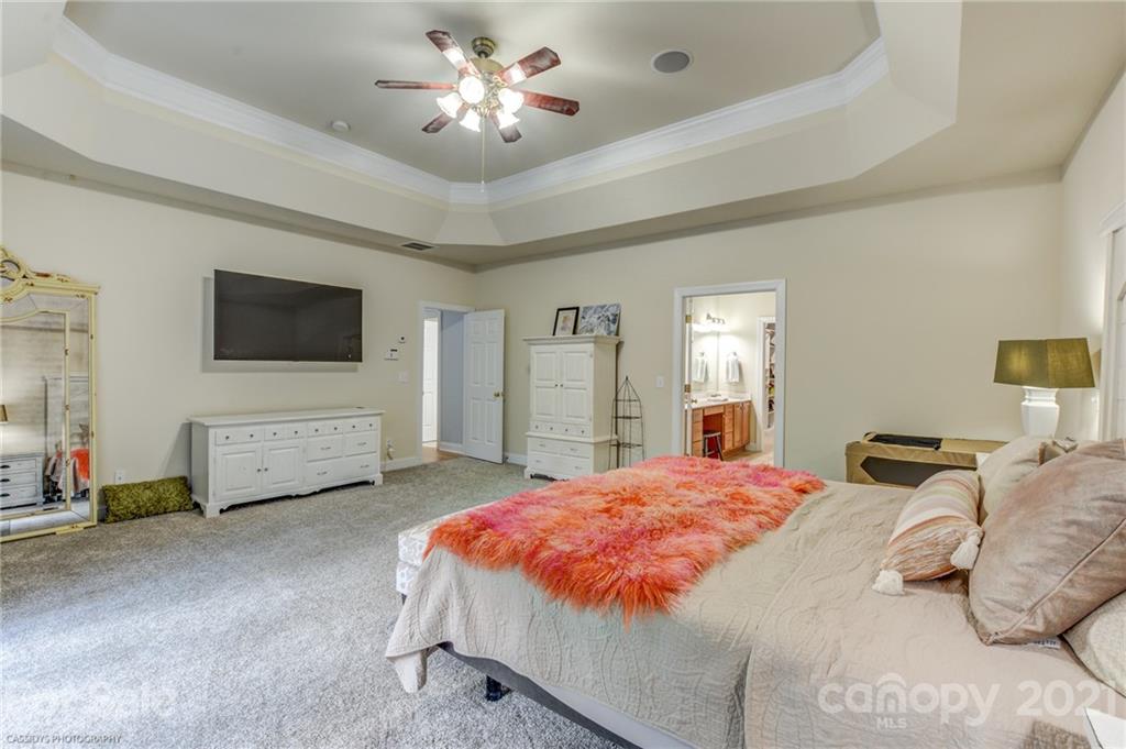 2678 Landing Pointe Drive Clover, SC 29710 - Photo 23 of 48 a spacious bedroom with a bed and a chandelier