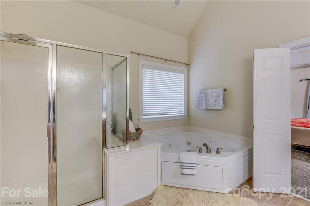 2678 Landing Pointe Drive Clover, SC 29710 - Photo 28 of 48 a bathroom with a bathtub sink vanity and mirror