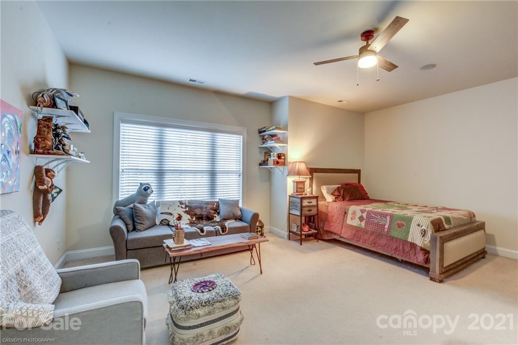 2678 Landing Pointe Drive Clover, SC 29710 - Photo 35 of 48 a bedroom with bed and a chandelier