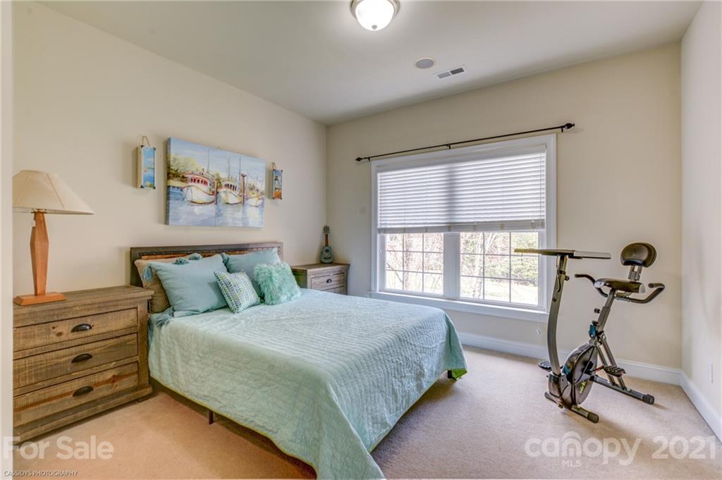 2678 Landing Pointe Drive Clover, SC 29710 - Photo 37 of 48 a spacious bedroom with a bed a couch and a window