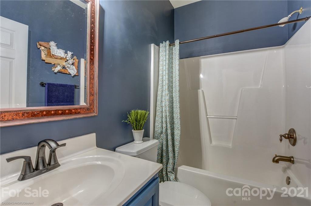 2678 Landing Pointe Drive Clover, SC 29710 - Photo 39 of 48 a bathroom with a sink and mirror with toilet