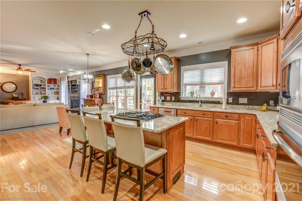 2678 Landing Pointe Drive Clover, SC 29710 - Photo 7 of 48 a kitchen with stainless steel appliances granite countertop counter space a dining table and chairs