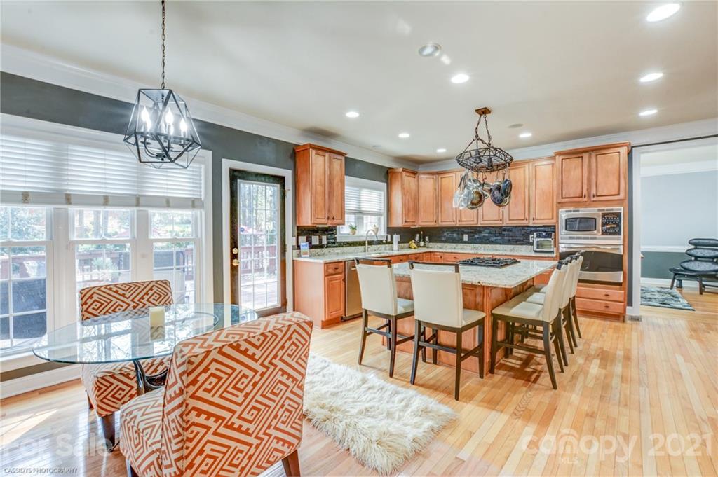 2678 Landing Pointe Drive Clover, SC 29710 - Photo 8 of 48 a dining room with stainless steel appliances granite countertop furniture wooden floor and a kitchen view