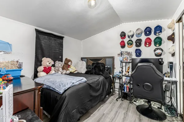 a bedroom with a bed and a chandelier