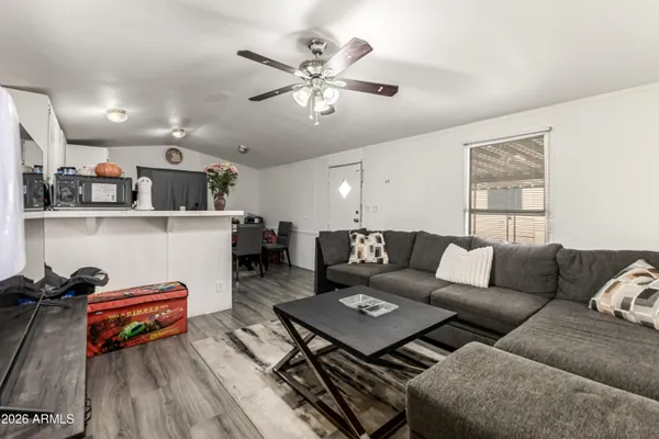 a living room with furniture and wooden floor