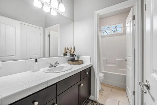 a bathroom with a granite countertop sink a shower and a mirror