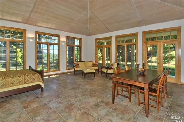 a living room with furniture and large windows