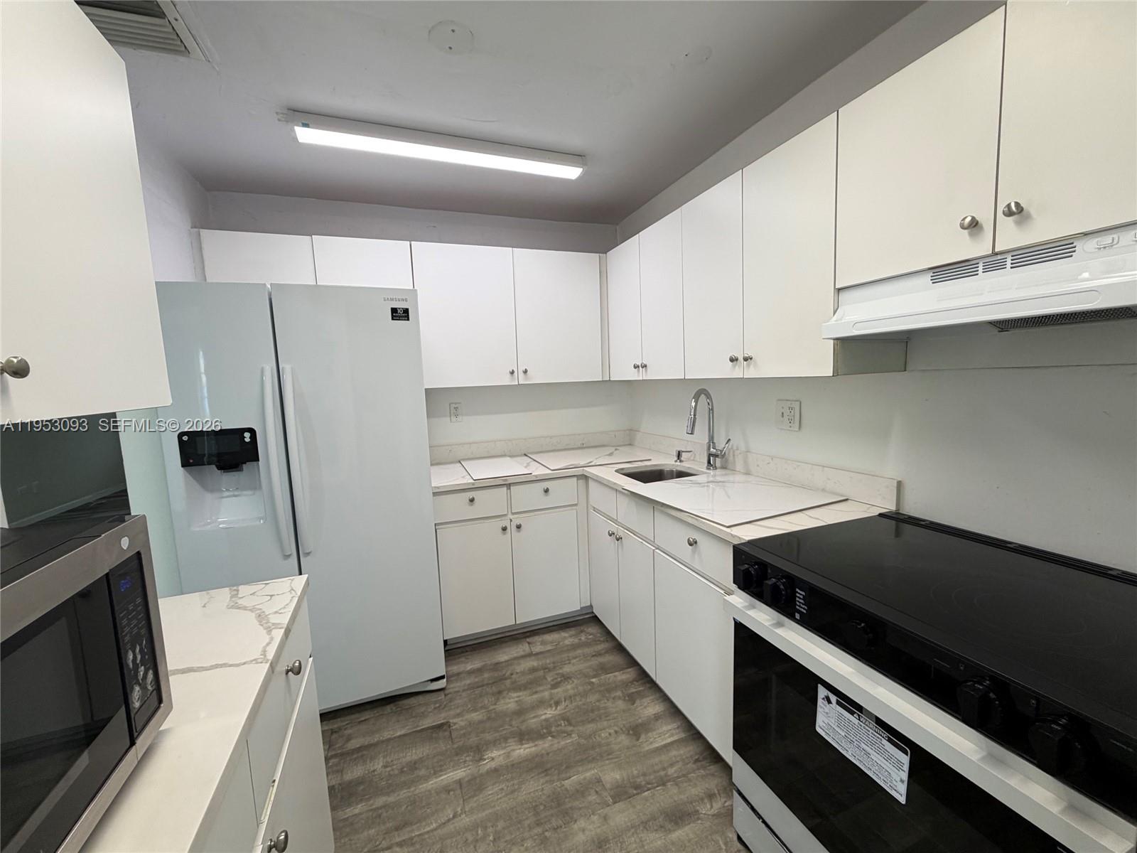 9503 Southwest 88th Terrace, Unit 9503 Miami, FL 33176 - Photo 4 of 15 a kitchen with a sink stove and refrigerator