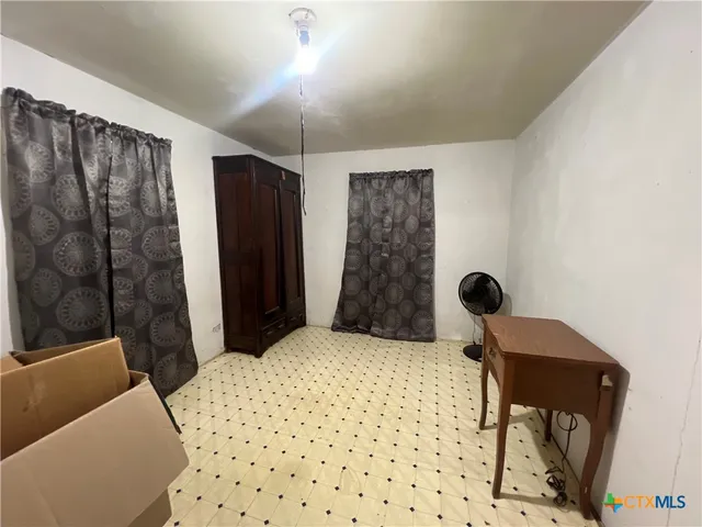 a bedroom with a bed and a chair