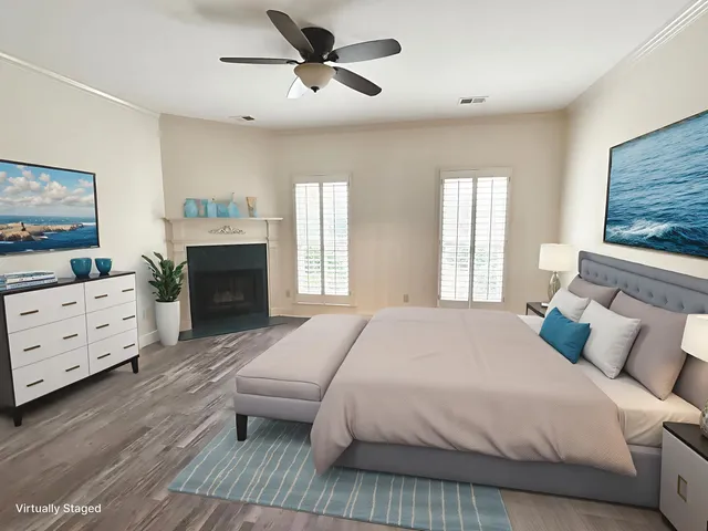 an empty room with wooden floor fireplace and windows