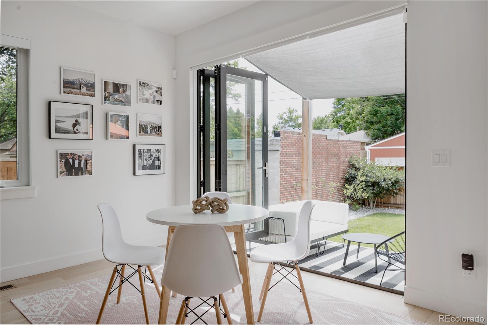 2645 Eudora Street Denver, CO 80207 - Photo 12 of 40 a view of a dining room with furniture window and outside view