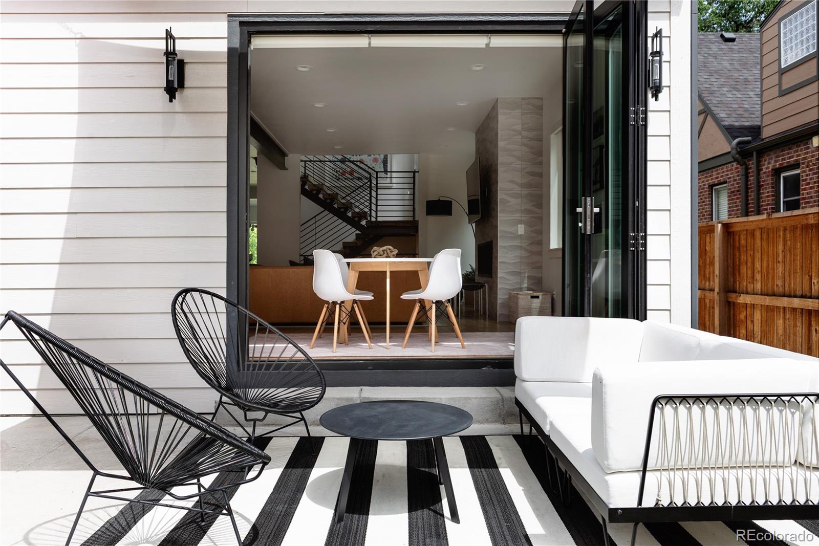 2645 Eudora Street Denver, CO 80207 - Photo 15 of 40 a balcony view with a dining table and chairs