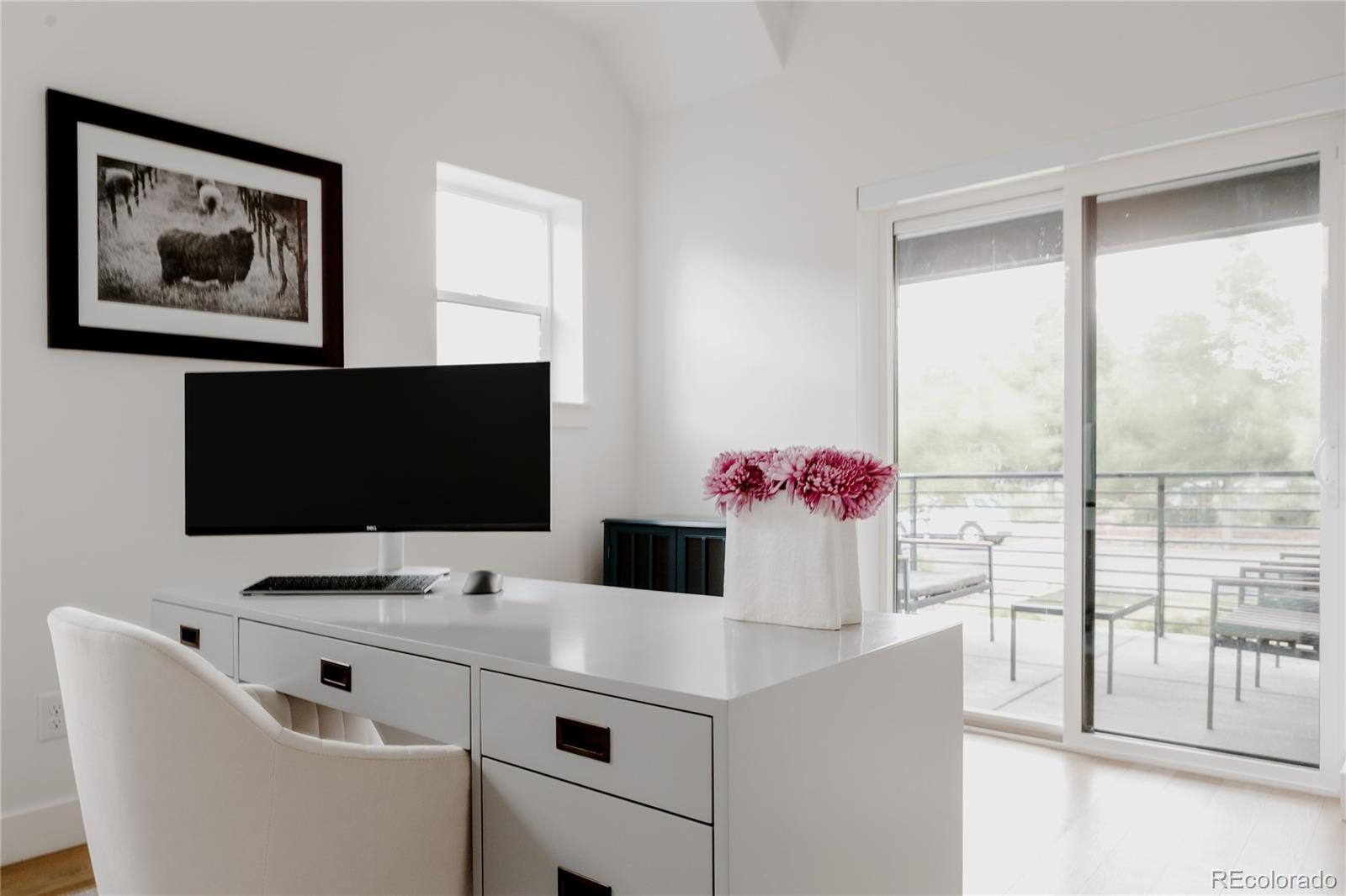 2645 Eudora Street Denver, CO 80207 - Photo 19 of 40 a work place with computer on desk and a large window