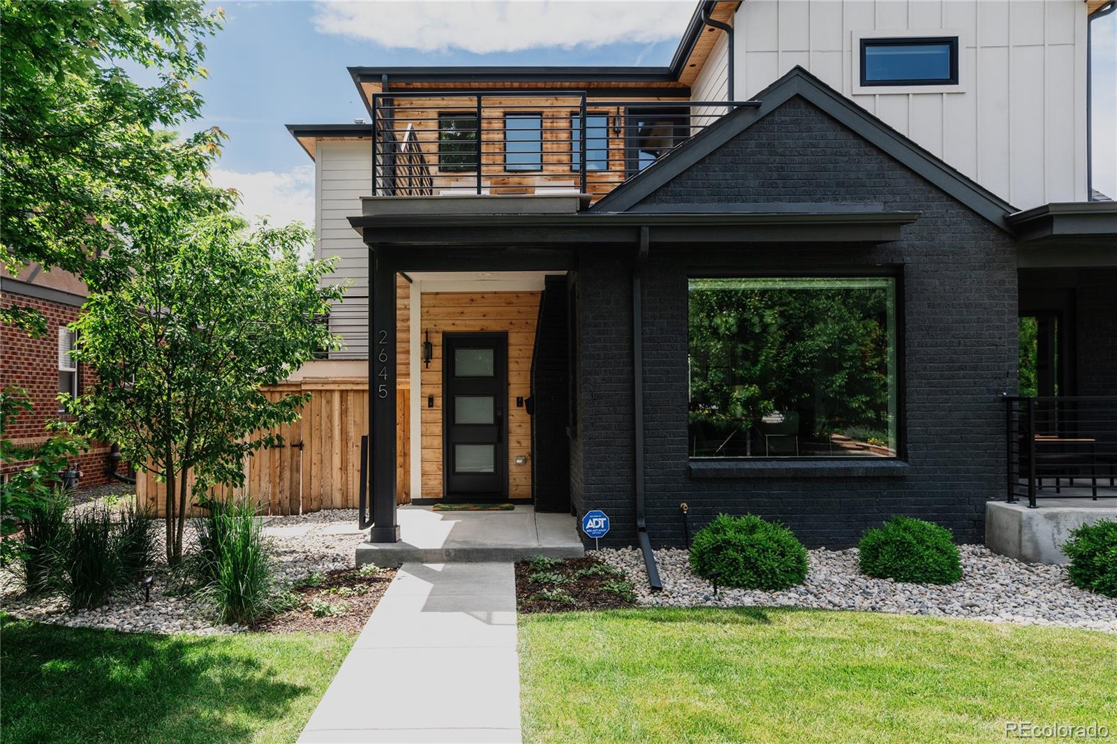 2645 Eudora Street Denver, CO 80207 - Photo 2 of 40 a front view of a house with garden