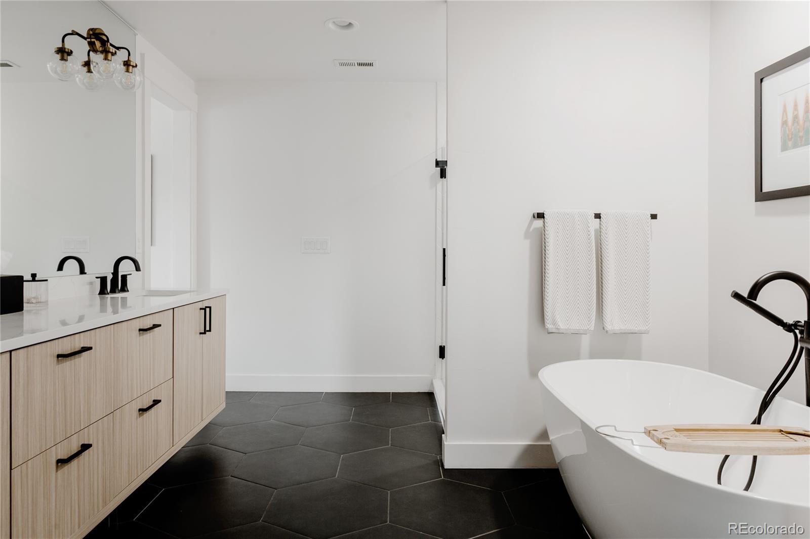 2645 Eudora Street Denver, CO 80207 - Photo 24 of 40 a bathroom with a tub sink and mirror