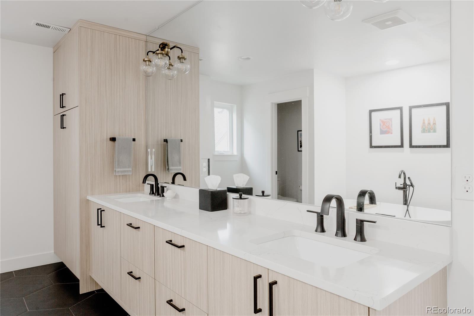 2645 Eudora Street Denver, CO 80207 - Photo 25 of 40 a bathroom with double sink and a mirror