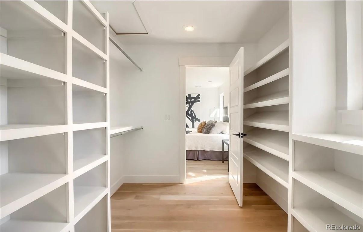 2645 Eudora Street Denver, CO 80207 - Photo 27 of 40 a view of walk in closet with empty racks