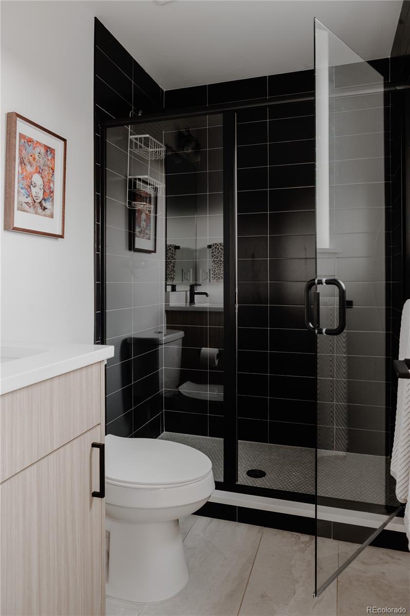 2645 Eudora Street Denver, CO 80207 - Photo 30 of 40 a bathroom with a toilet and a shower