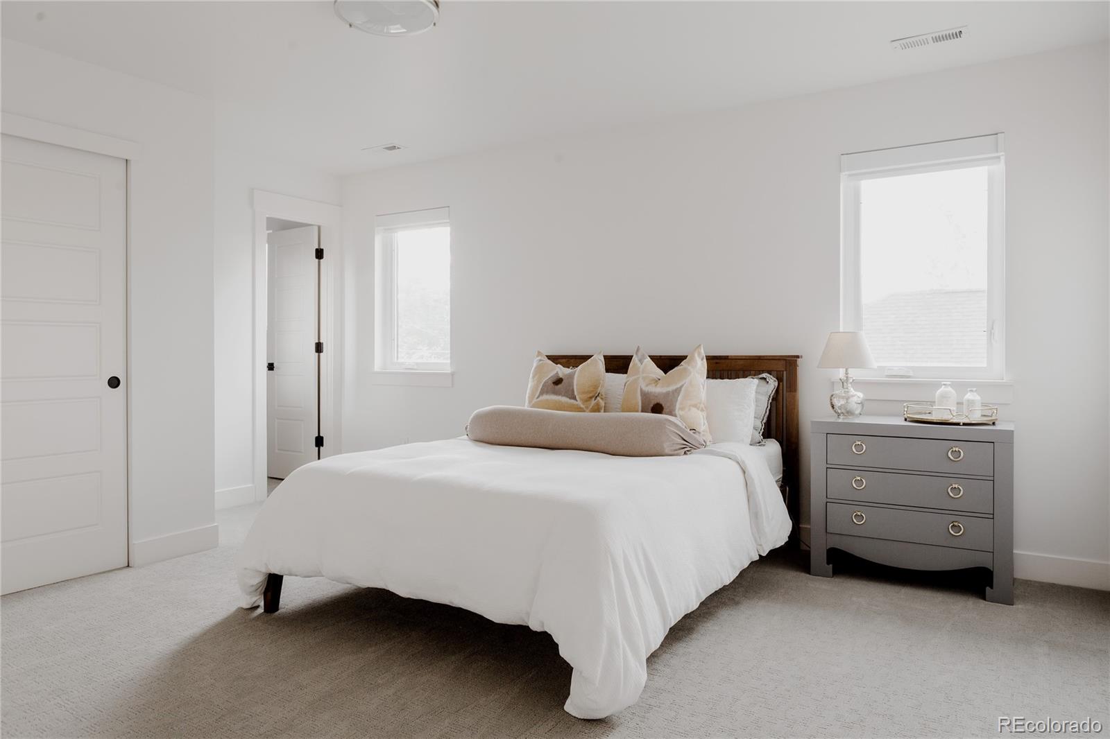 2645 Eudora Street Denver, CO 80207 - Photo 31 of 40 a bedroom with a bed and a window