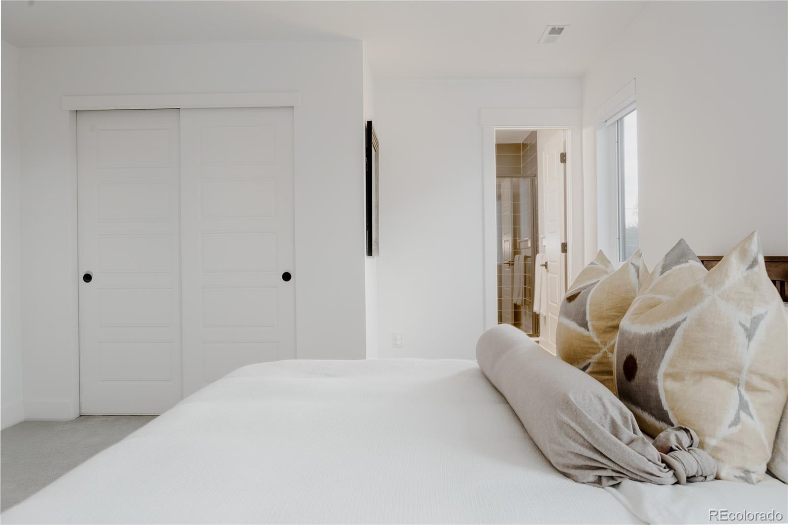 2645 Eudora Street Denver, CO 80207 - Photo 32 of 40 a bedroom with a bed and a couch