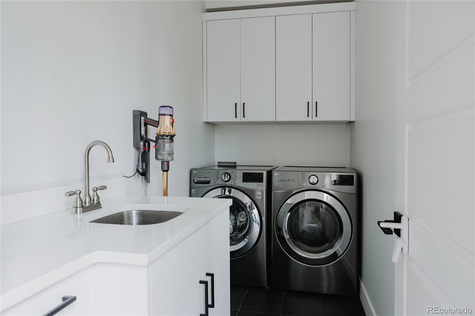 2645 Eudora Street Denver, CO 80207 - Photo 34 of 40 a view of a kitchen with sink and washing machine